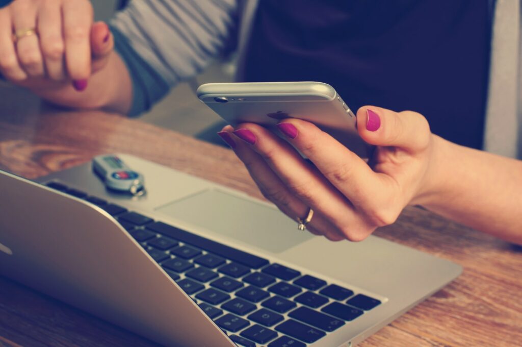 Woman composing emails or text messages on her phone.